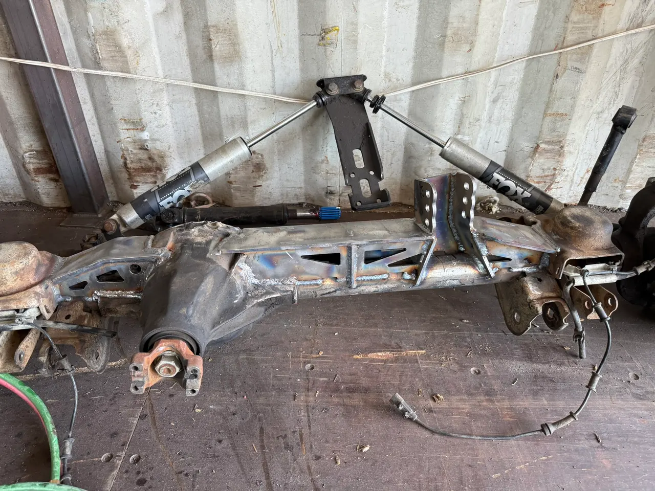 Automotive axle with a fitted steel truss and brackets in the workshop