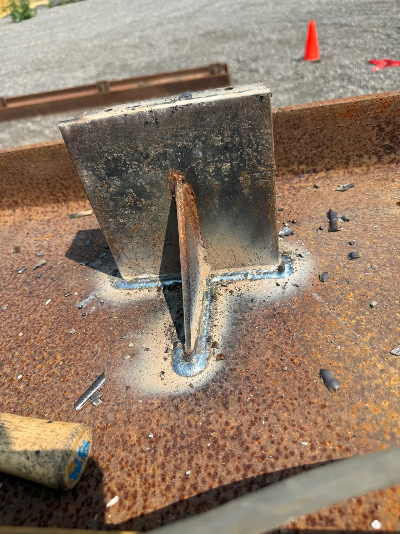 Fabricated steel bracket welded onto a structural beam