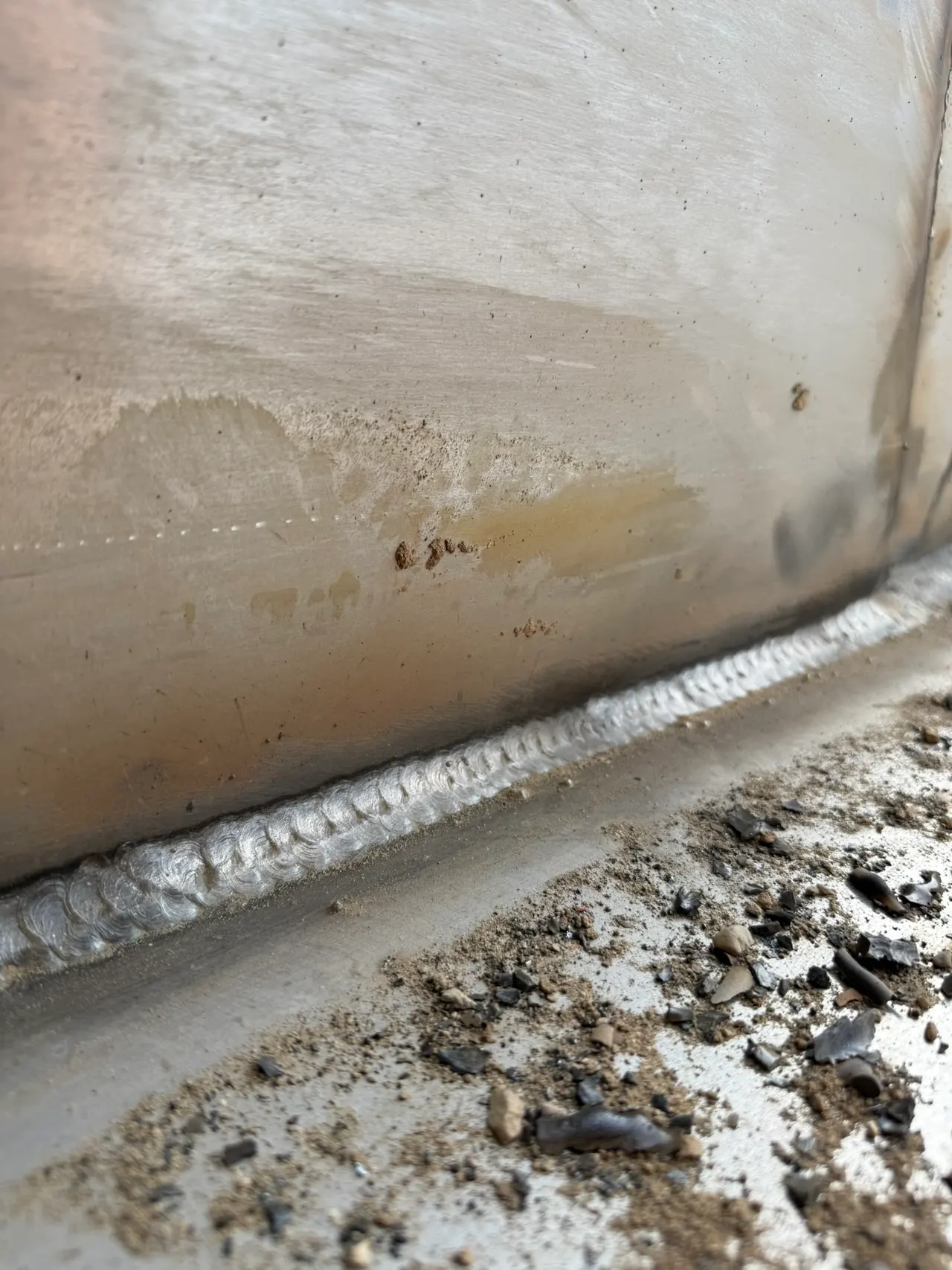 Close-up of a weld along a heavy steel equipment component