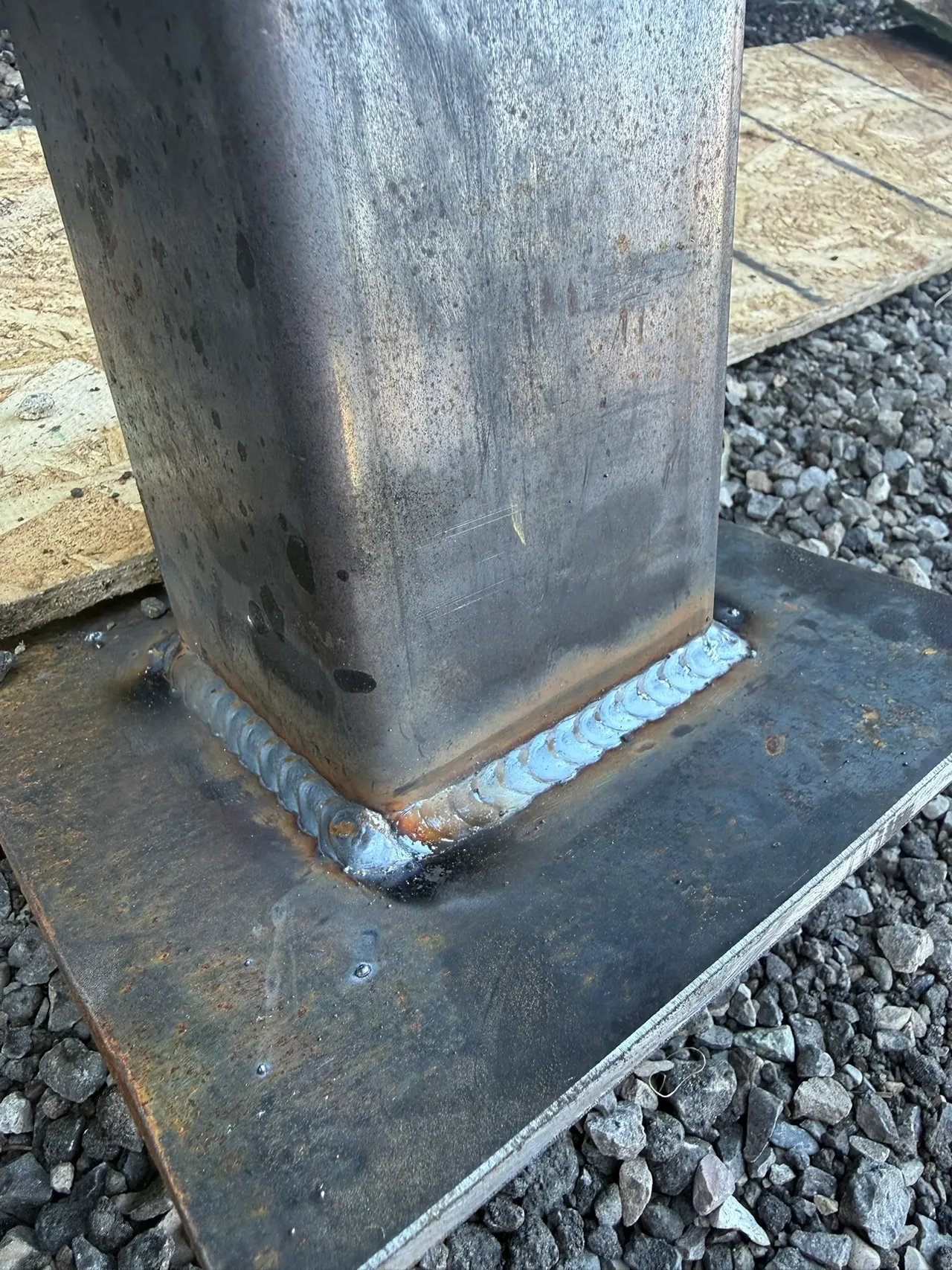 Weld joining a square steel post to a flat base plate