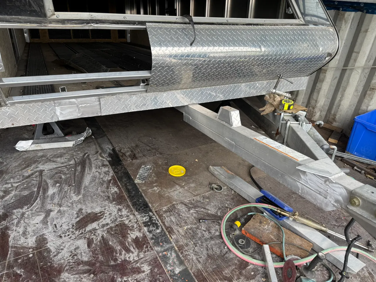 Trailer tongue and coupling assembly with surrounding steel frame