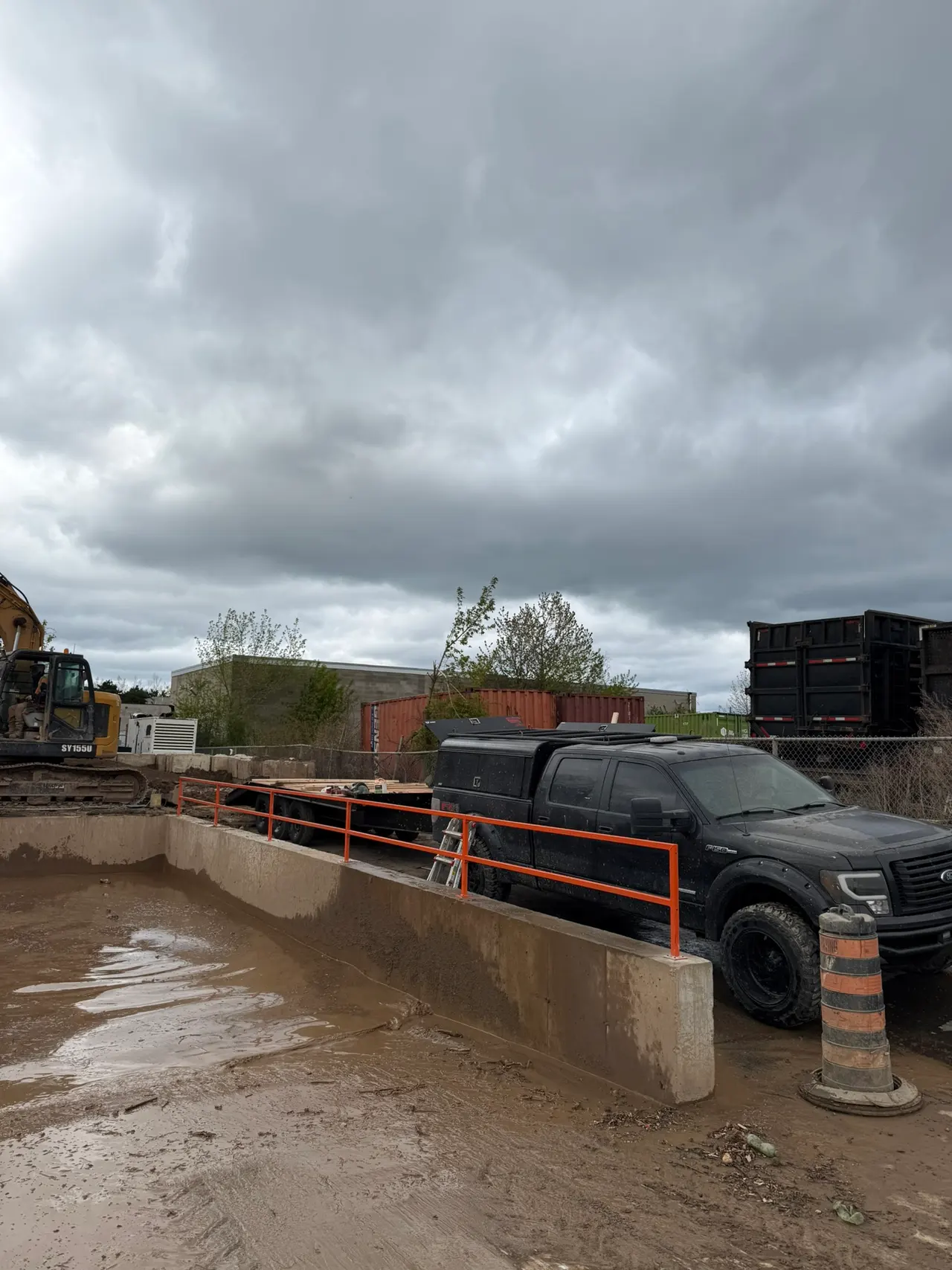 Installed orange railings along the concrete edge of the washout plant pit